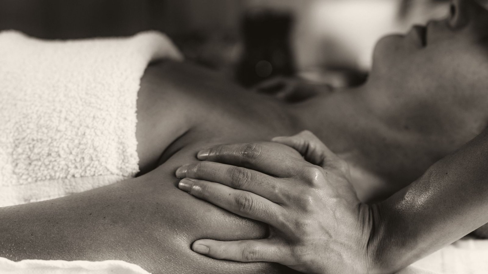 Hands working on a shoulder during a massage